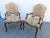 A pair of Louis xv style open arm chairs, Walnut frames with floral tapestry upholstery, cabriole legs with brass nail...