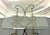 Vintage scroll wrought iron and brass accent table from the late 20th century. The base is made of wrought iron and...