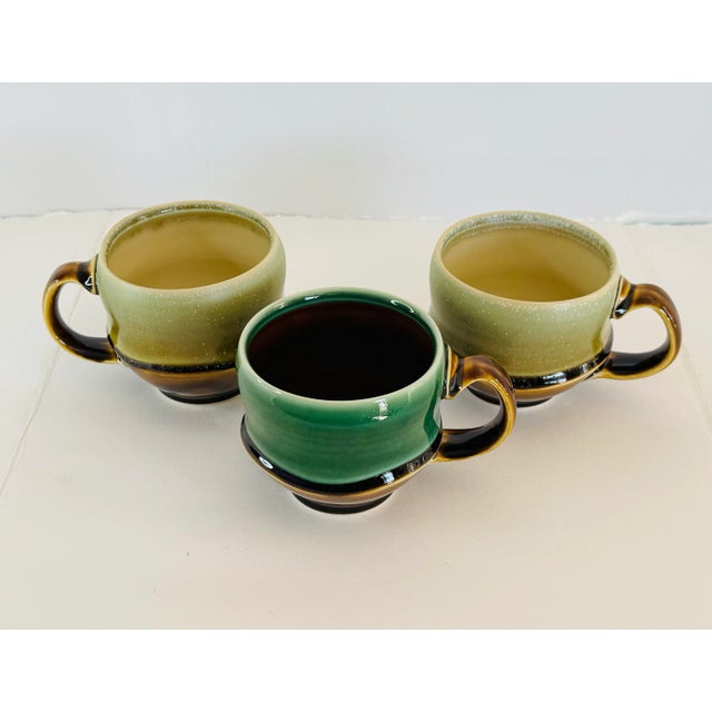 Ryan J. Greenheck Studio Pottery Mugs, Set of 3. Hand made by this Philadelphia potter. One solid green mug and other two...
