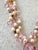 A uniquely designed freshwater pearl necklace inclusive of gorgeous pink crystal detailing and silver metal flower...