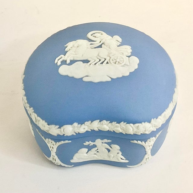 This is a pretty Wedgwood Blue Porcelain Trinket Box. The English Hollywood Regency style box features Greek Hellenic and...