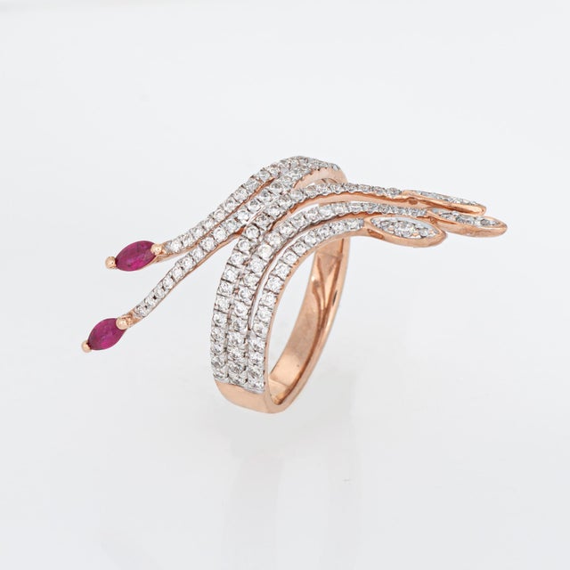 Stylish contemporary ruby & diamond spray ring crafted in 9 karat rose gold. 2 marquise cut rubies measure 4mm x 2mm....