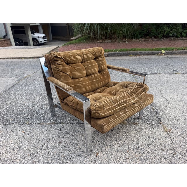 Milo Baughman style chrome flat bar lounge chair. The chair features a chrome frame and upholstery seating. The upholstery...