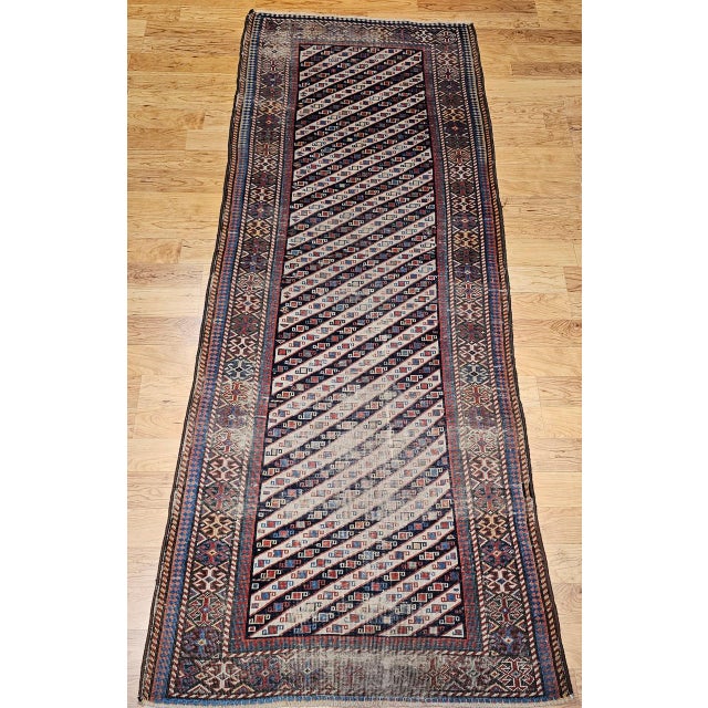 A beautiful and colorful vintage Caucasian Gendje Kazak runner from the fourth quarter of the 19th century — an unusually...