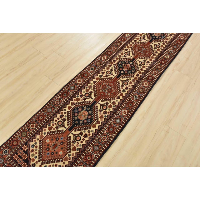 An authentic vintage tribal Yalameh runner hand-knotted with fine wool and natural dyes. This intricately woven rug...