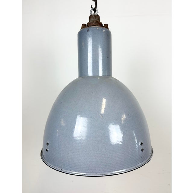 Vintage Industrial light in Bauhaus style made in former Czechoslovakia during the 1950s.It features a grey enamel body...