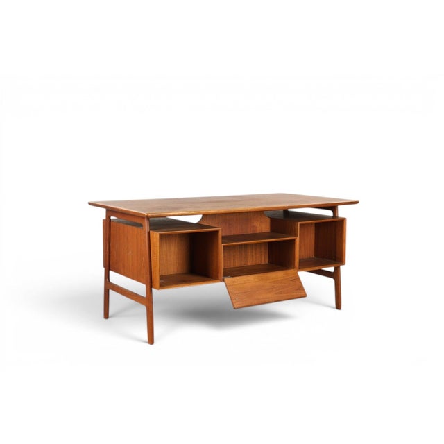 A sculptural Model 75 writing desk designed by Gunni Omann for Omann Jun in the 1950s, with a drop-down door front in...