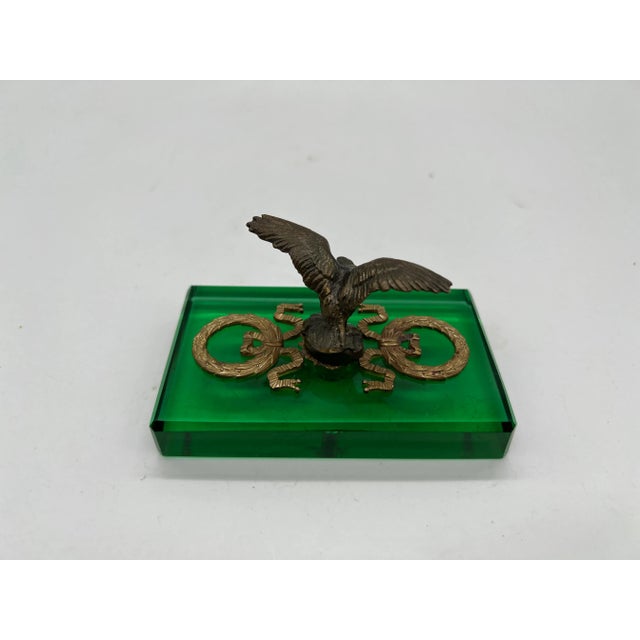 French, early 20th century. An antique French empire style paperweight. The paperweight features an emerald green glass...