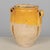 An earthenware confit pot from the Southwest of France with traditional yellow glaze. Chips and losses to glaze. These...