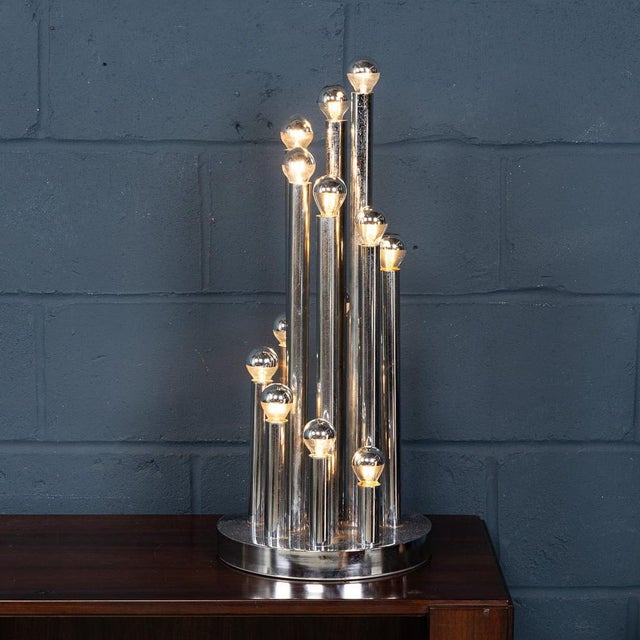 A striking and sculptural table lamp by reggiani, italy, dating to the 1970s. The design features an arrangement of...