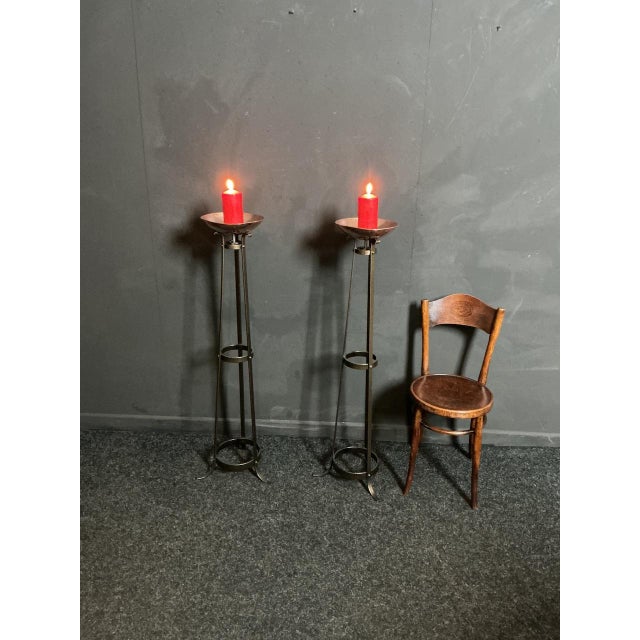 The torcheres are fully restored. Sand blasted and then powder coated to a bronze finish. Copper drip pans polished....