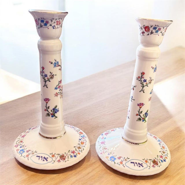 These sculptural candlesticks feature a graceful columnar form with subtle textural elements and rich gold embellishment,...