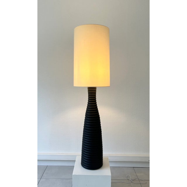 An important black glazed ceramic table lamp/floor lamp, France circa 1990. A very spectacular and decorative lamp!...