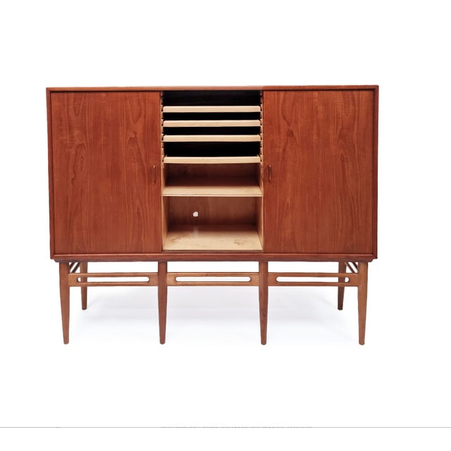 Danish teak highboard credenza/sideboard from the 1960s, showcasing a stunning mid-century modern design. Its simplicity...