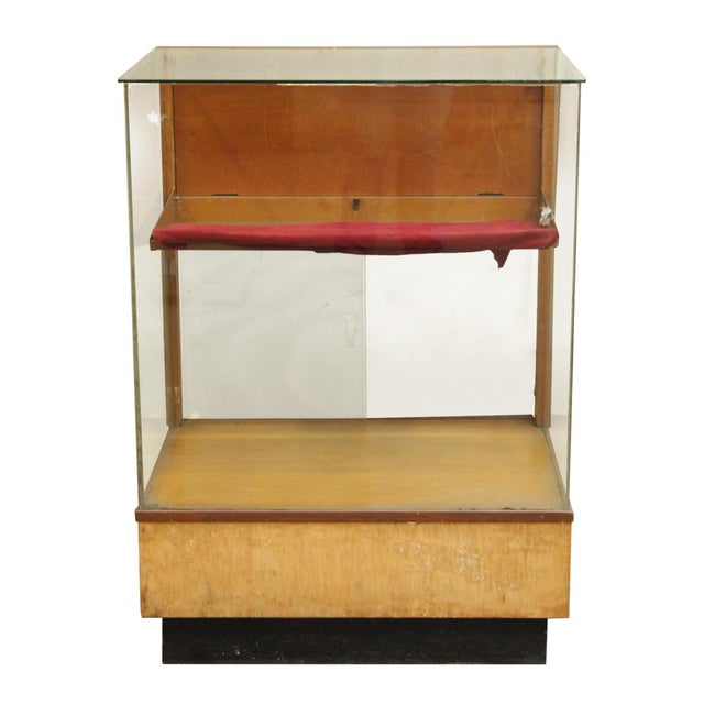 1950s golden oak wood showcase with three glass panel sides and black trim. Back folds down for easy access to the oak...