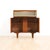This fabulous mid century bar cabinet was made in England during the 1960s. Produced in teak, the top cabinet doors open...