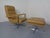 Mustard-colored, swivel leather armchair with ottoman from the 1960s. According to the previous owner, it was made in...