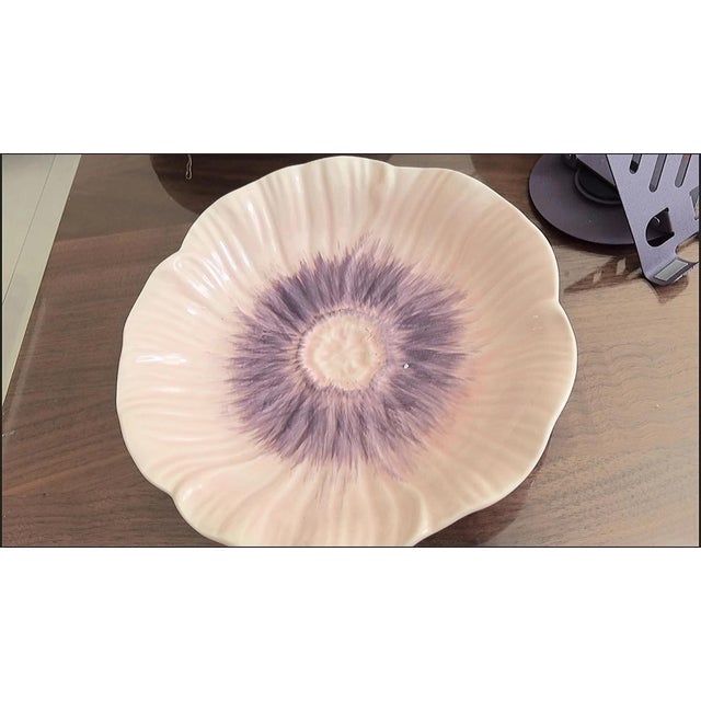 Made of ceramic, the glaze technique creates a gradient effect of pale pink and purple. The plate is designed in the shape...
