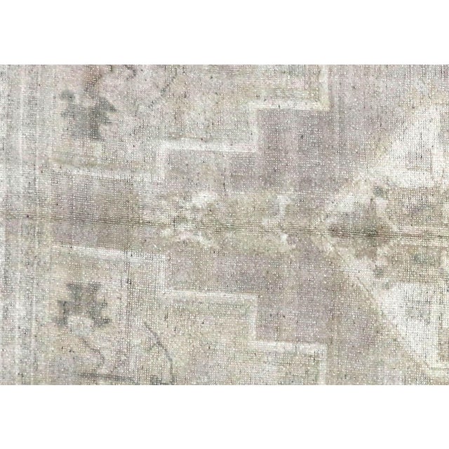 This vintage Turkish Oushak rug, sized 6' x 10', is handwoven from wool on a wool foundation in the Oushak region of...