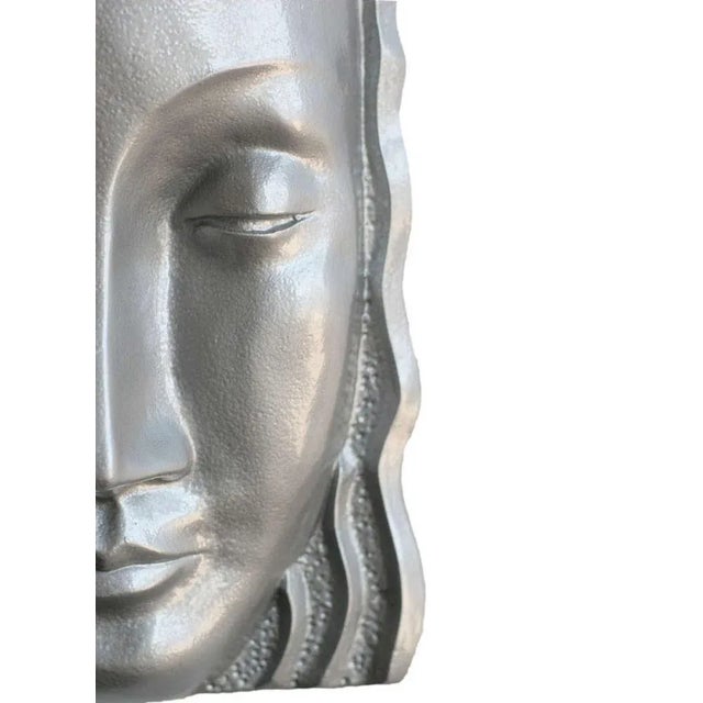 Art Deco Sculptural Female Face Wall Sconce made of Fiberglass with a silver-tone enamel finish. The wall sconce resembles...