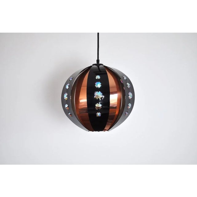 Coronell of denmark pendant designed by werner schou. black and copper metal stripes with faceted glass "jewels" gives a...