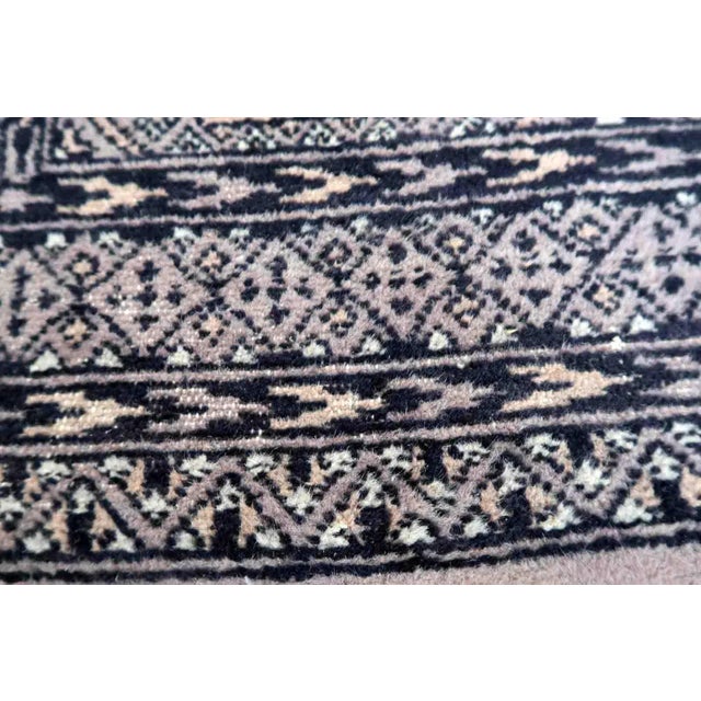 Handmade vintage Uzbek Bukhara rug in traditional design and red color. The rug is from the end of 20th century in...