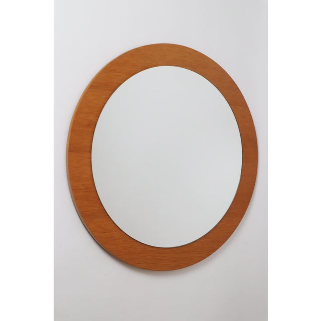 Beautiful, simple, round wall mirror. The mirror glass is simple and timeless and fits into any style of home. The wood on...