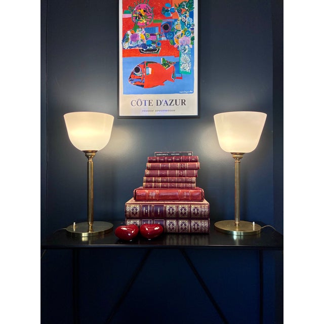 Two "Senator" lamps in brass with white opaline tulip shades. Push-button switch on the base. Electrical connection in...