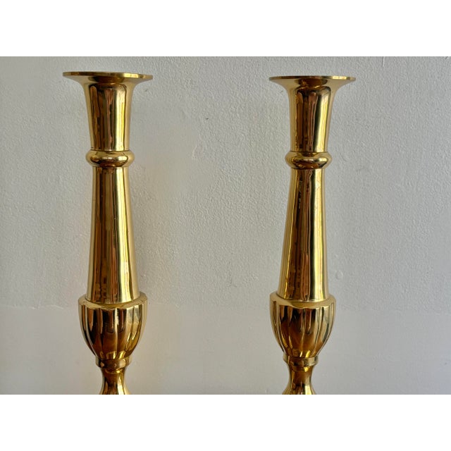 Tall pair of Traditional Hampton brass candleholders with oval bases. An elegant accent on your table or mantle. Stamped...