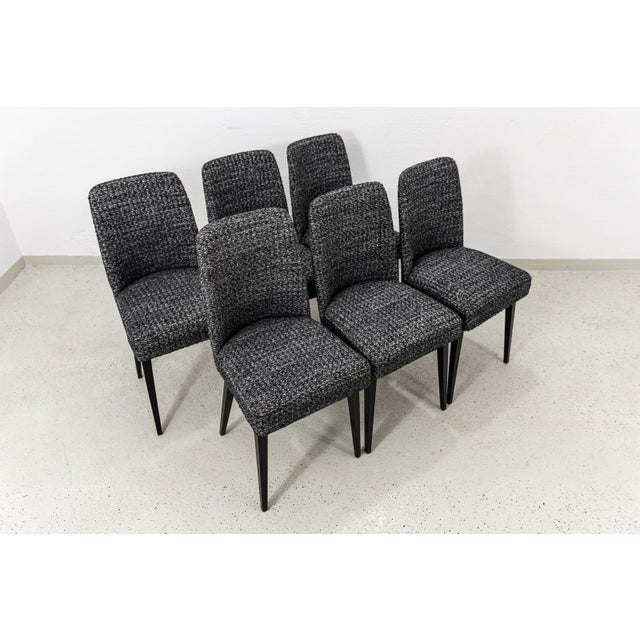 A set of six upholstered dining chairs, produced by the Fabryka Mebli w Swarzędziu, Poland, 1960s. The shell-shaped...