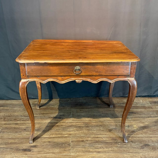 Elegant and classic 19th century French Louis XV side table crafted in warm walnut with a beautifully aged surface and...