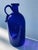 Wonderful blue bottle with profiled and polished rim. the peculiarity of the bottle is the wide handle and the serpentine...