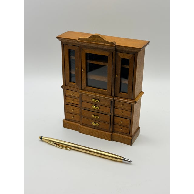 A finely crafted vintage Shackman dollhouse miniature hutch cabinet, made in real wood with glass-front doors and detailed...