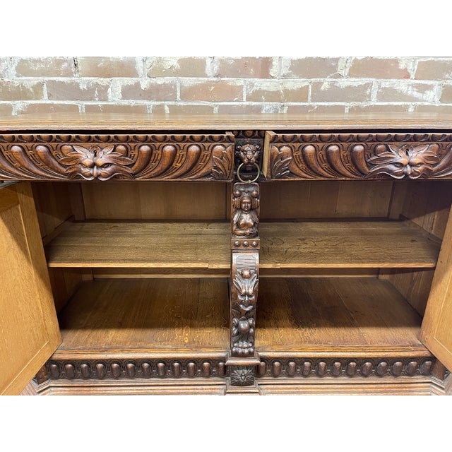 Circa 1890 French Renaissance Revival carved oak sideboard featuring highly ornate, deep dimensional wood carvings...