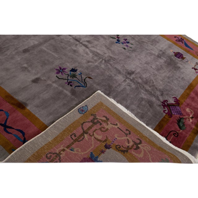 Beautiful antique Art Deco hand-knotted wool rug with the gray field. This Chinese rug has a burgundy and goldenrod frame...