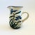 A vintage studio pottery pitcher. Pale gray base glaze with a lovely hand painted blue iris design with green leaves....