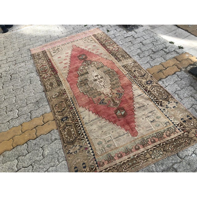 This is a vintage Turkish Oushak rug from the 1960s. The piece was hand-knotted.