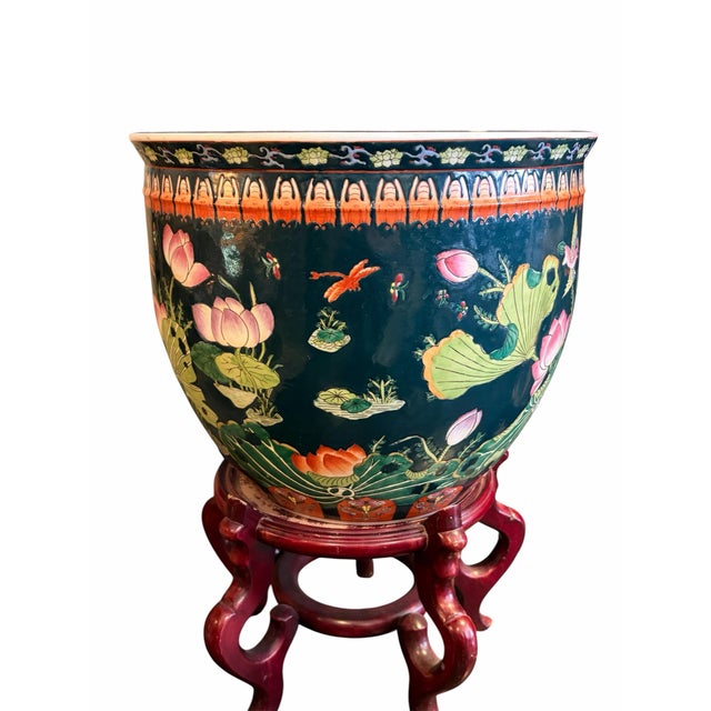 This decorative porcelain bowl planter by Maitland-Smith features hand-painted floral, lotus, and goldfish motifs over a...