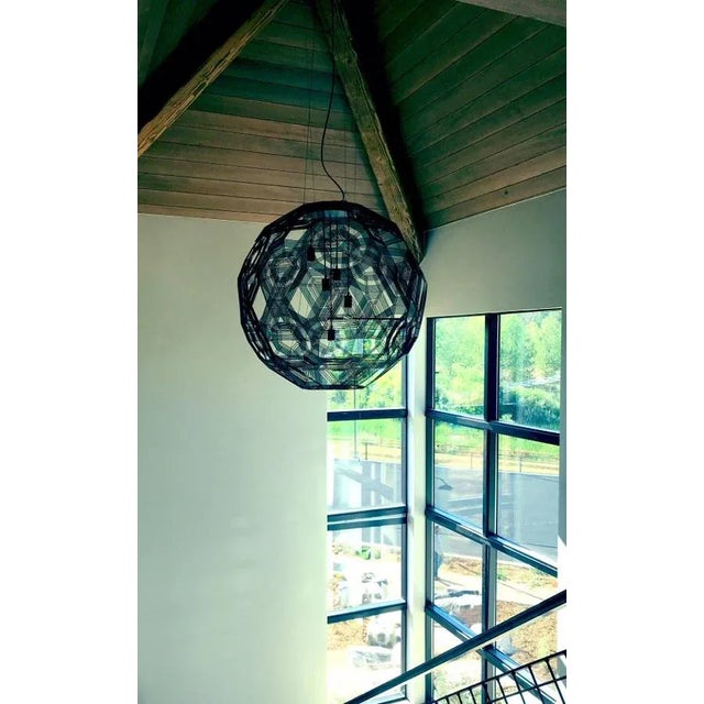 Handmade from malleable galvanized iron wire, the Zattelite 10 pendant by Schema for Oggetti presents a dramatic, large-...