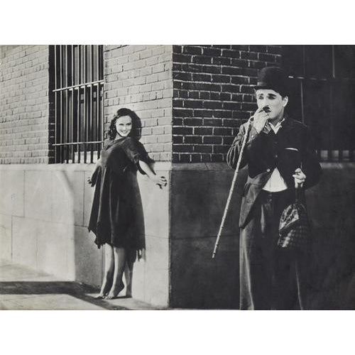 Charlie Chaplin is a vintage black and white photograph realized during the 1930s. Includes a wood frame. This pretty...