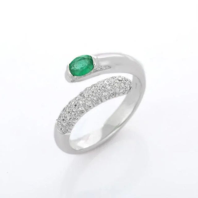 Emerald open ring in 18K gold with diamonds which perfectly goes with your personality and also helps you to improve your...
