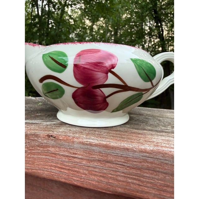 A charming mid-century hand-painted ceramic gravy boat produced by Blue Ridge Southern Potteries in the United States....