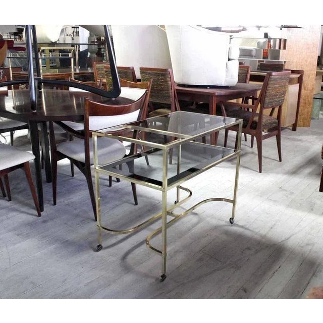 Mid century modern serving cart with smoked glass on wheels. Made in the mid 20th century.