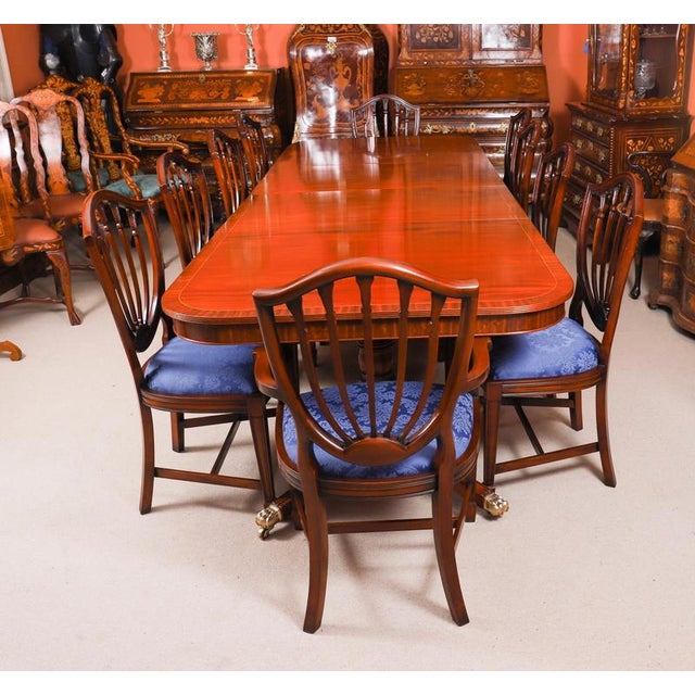 This is a fabulous high quality antique flame mahogany Regency revival twin pillar dining table and a set of ten...