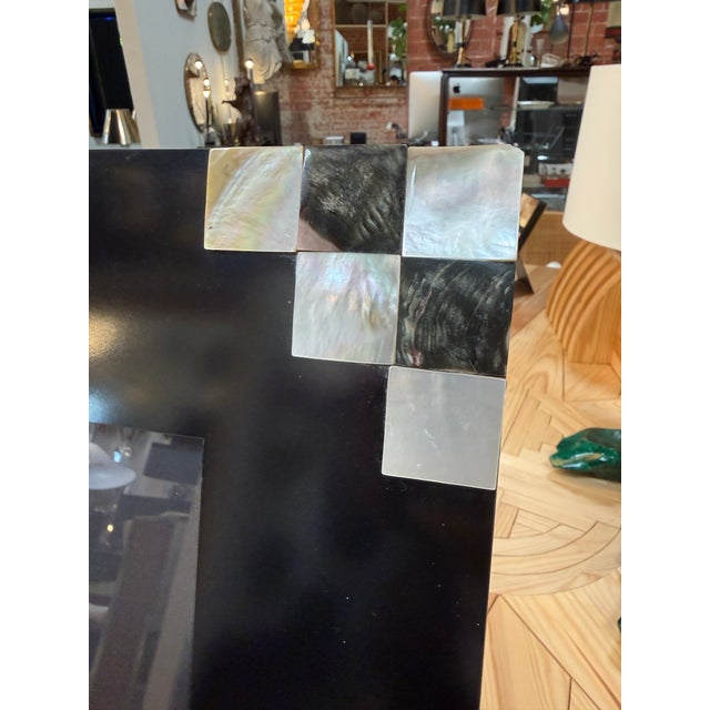Elegant picture frame by Tommaso Barbi, featuring a wide black surround accented with geometric mother-of-pearl squares at...