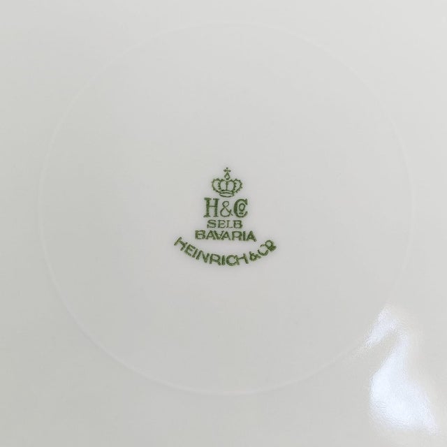 Gilded with 22k gold, this exquisite set of 4 vintage porcelain dinner plates by Heinrich & Co., Selb Bavaria showcases...