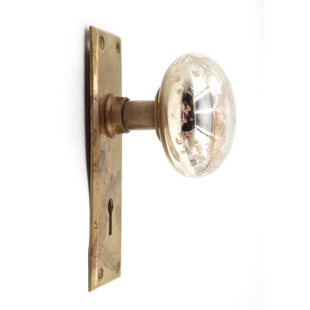 Antique dummy door set with a mercury glass knob on a rectangular shaped brass back plate. The original mounting screws...