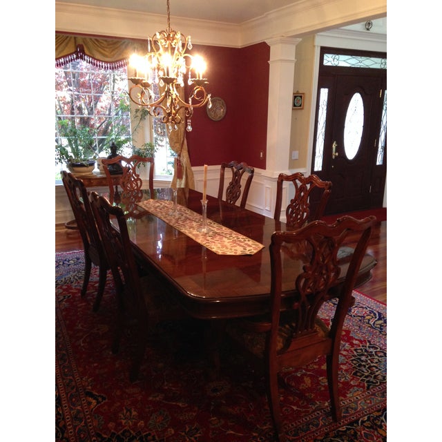 The dining table has a high gloss mahogany- like finish in traditional American Chippendale style. It has a classic,...