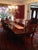 The dining table has a high gloss mahogany- like finish in traditional American Chippendale style. It has a classic,...