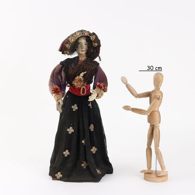 Figure of a Woman with face and hands in carved and painted wood. Contemporary dress. This piece is attributed to the...